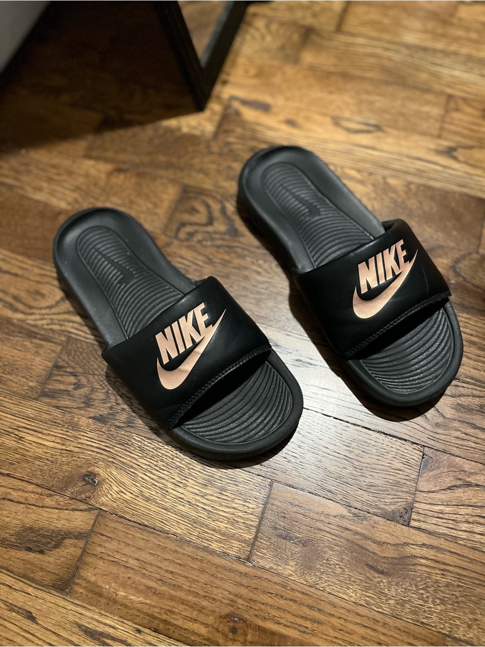 Nike Kids Black Slides with Metallic Rose Gold Logo